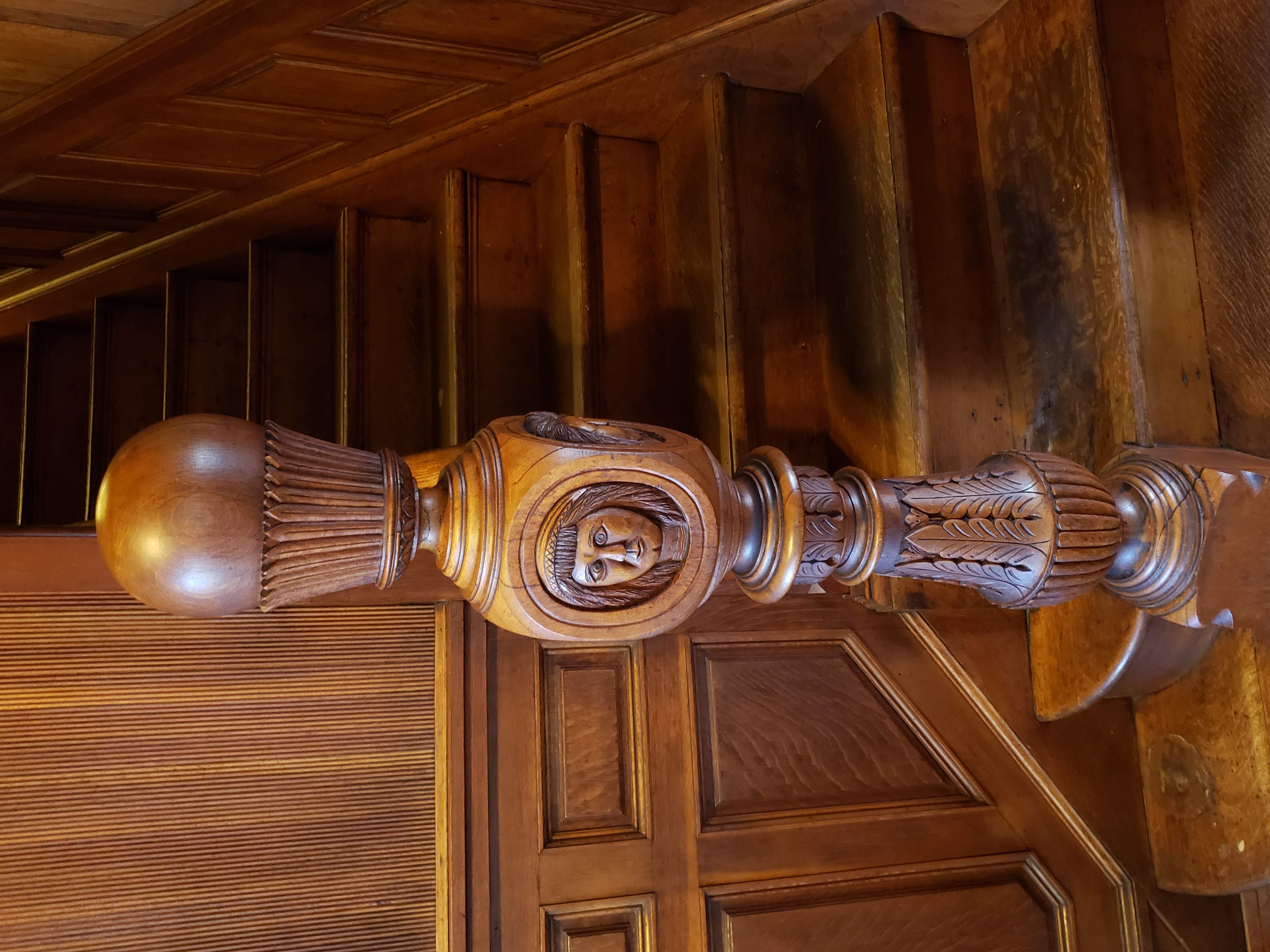Victorian newel-post carving with faces honoring Native American history